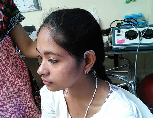 Indian girl wearing a hearing aid